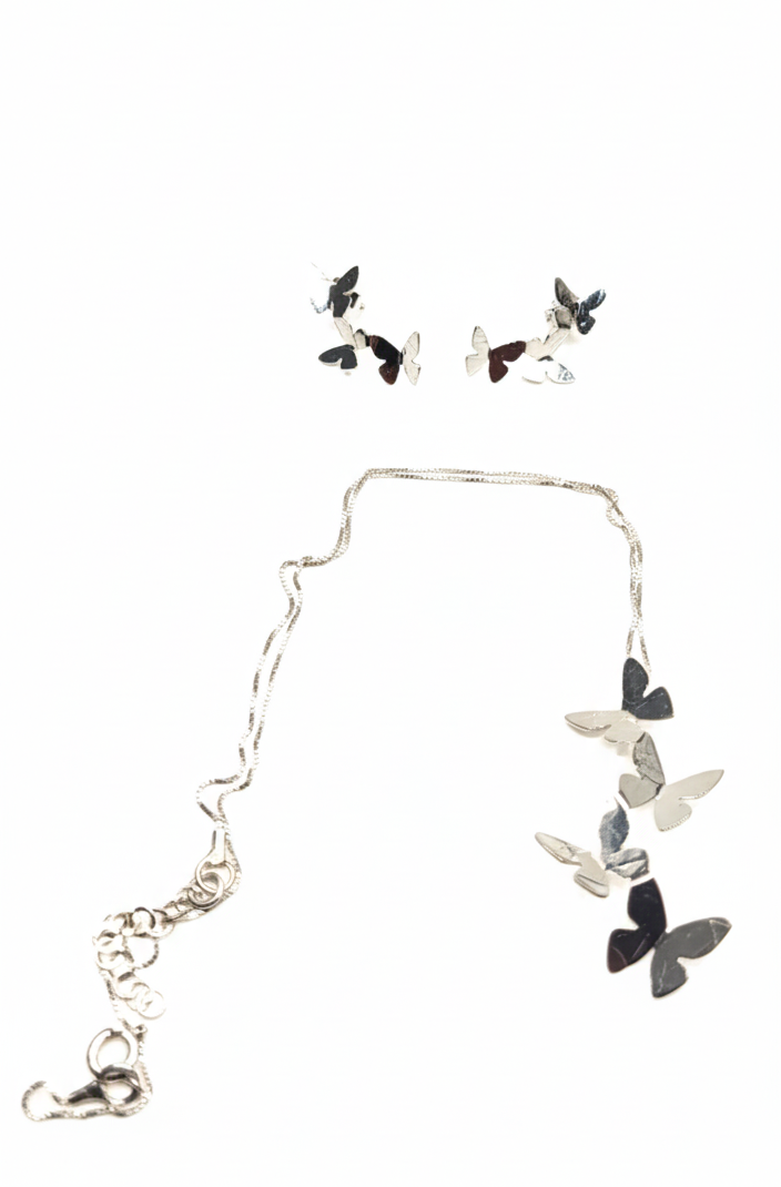 Butterfly necklace and earrings set on a white background