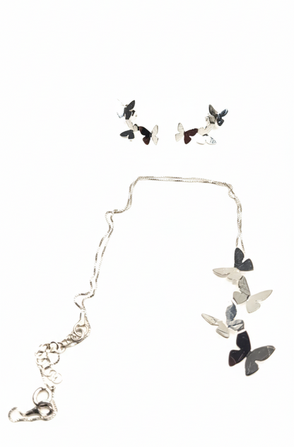 Butterfly necklace and earrings set on a white background