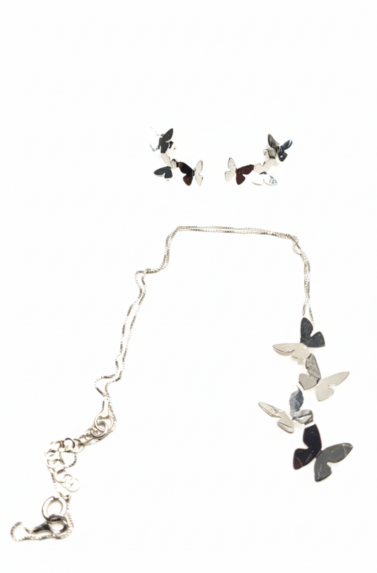 Butterfly necklace and earrings set on a white background