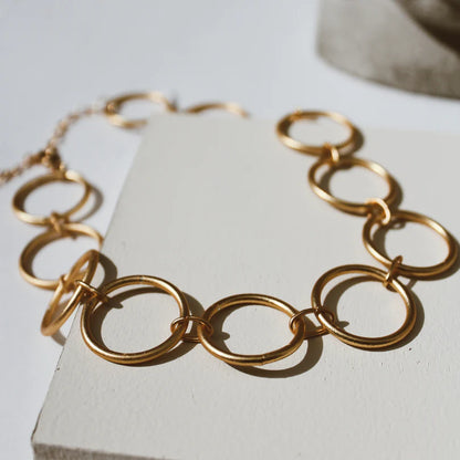 Circle Choker Golden Necklace on a light background