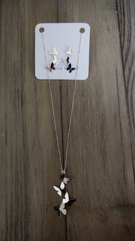 Necklace with a butterfly pendant on a wooden surface