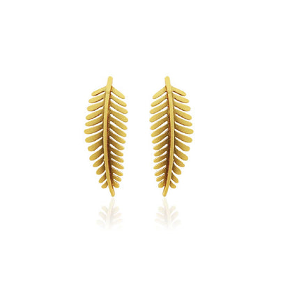 Golden fern-shaped earrings on a white background