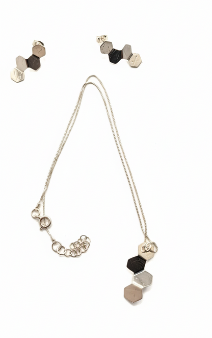 Necklace with geometric pendant and matching earrings on a white background