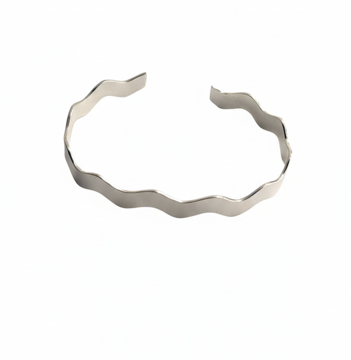 Silver bracelet with a wavy design on a white background