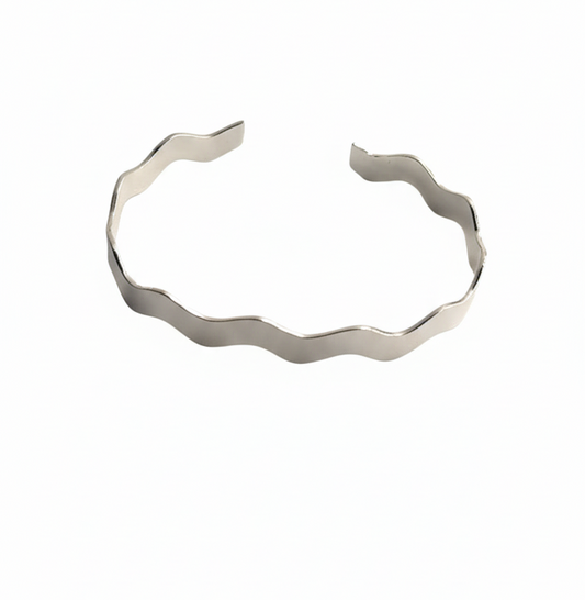 Silver bracelet with a wavy design on a white background