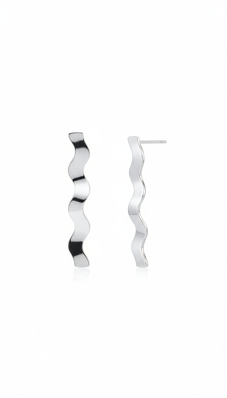 Silver wavy earring worn by a person with a blurred background