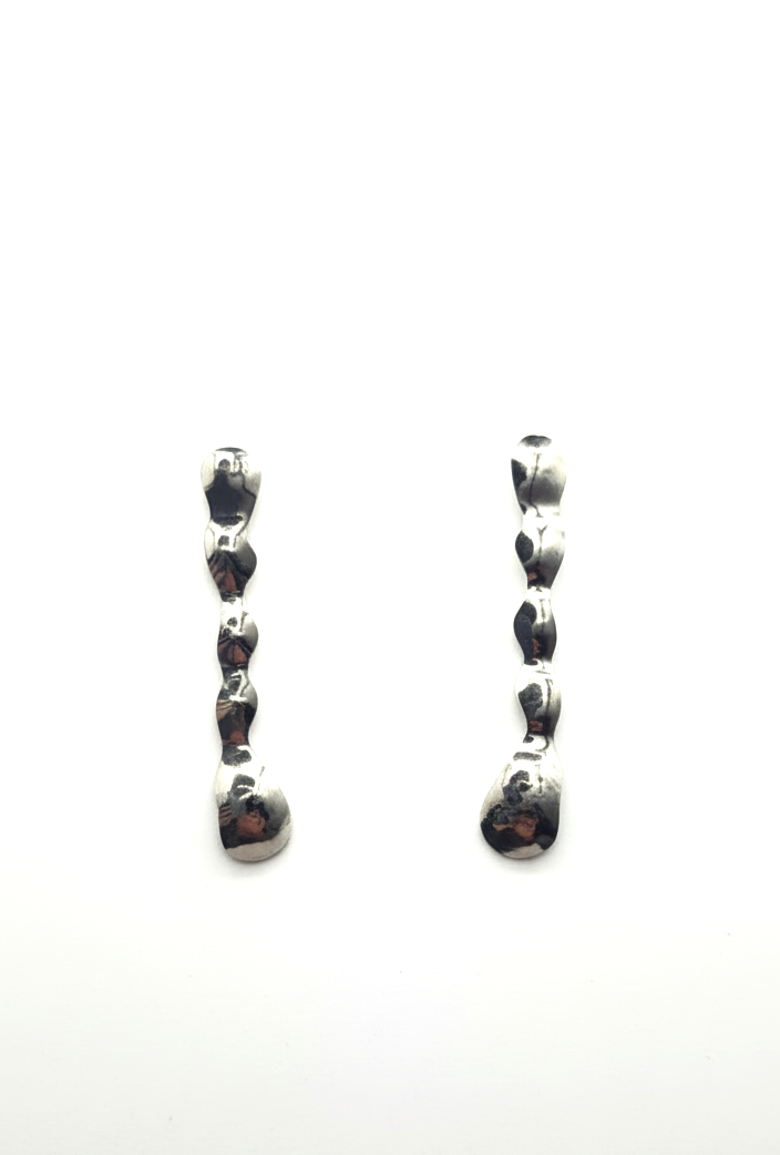 Pair of earrings with black gemstones on a white background