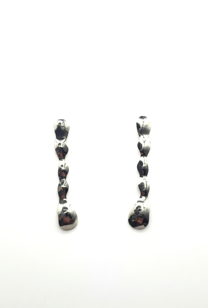 Pair of earrings with black gemstones on a white background